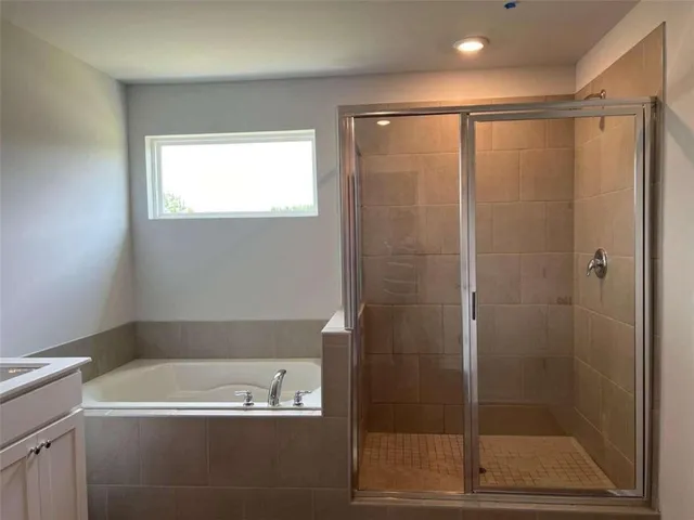 a bathroom with a shower and a bathtub