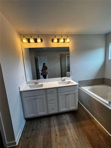 a bathroom with a sink vanity and a mirror