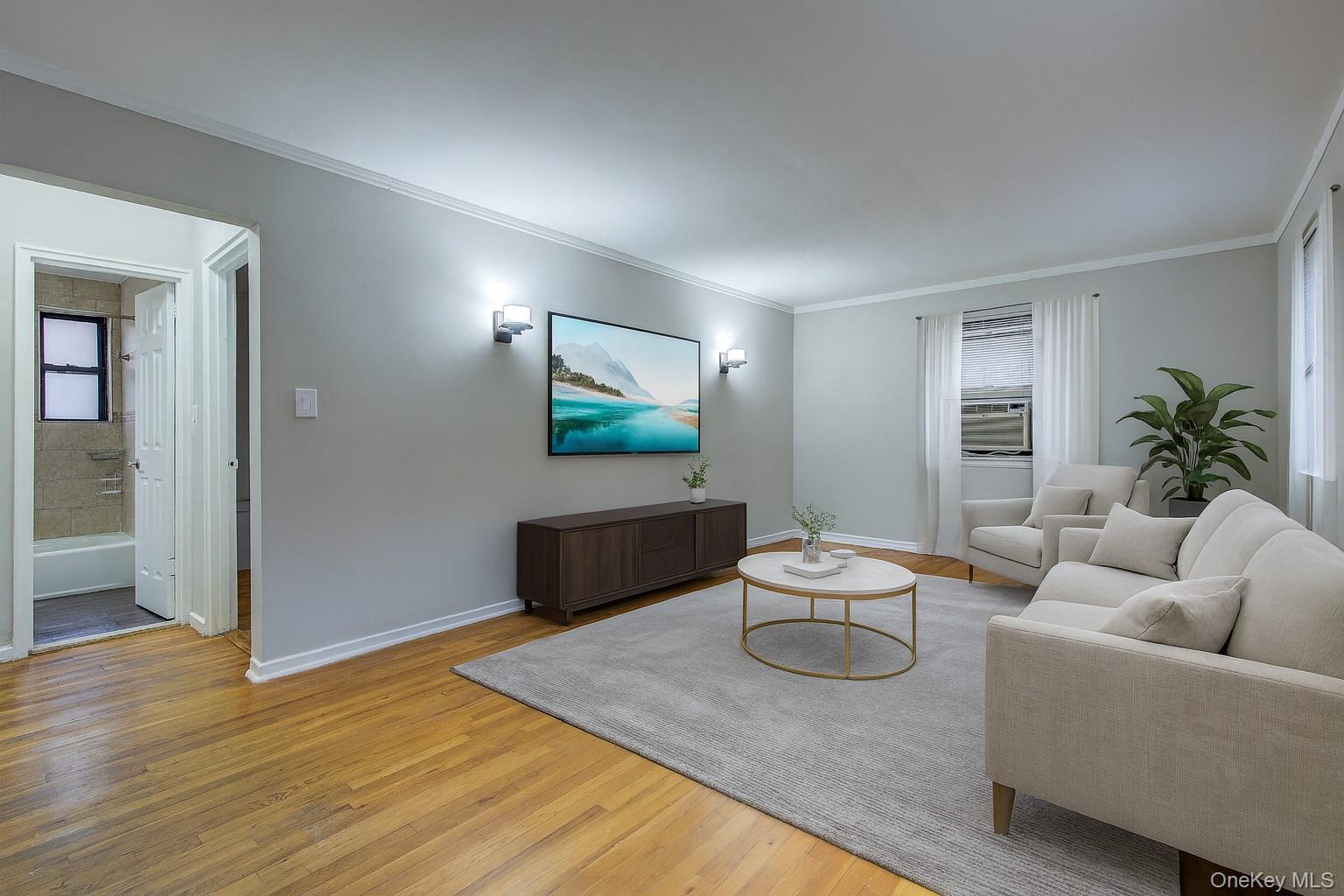 46-42 215th Place, Unit 1C Queens, NY 11361 - Photo 12 of 28 a living room with furniture and a flat screen tv