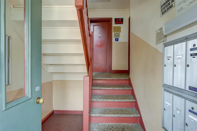 a view of staircase with white walls and a window