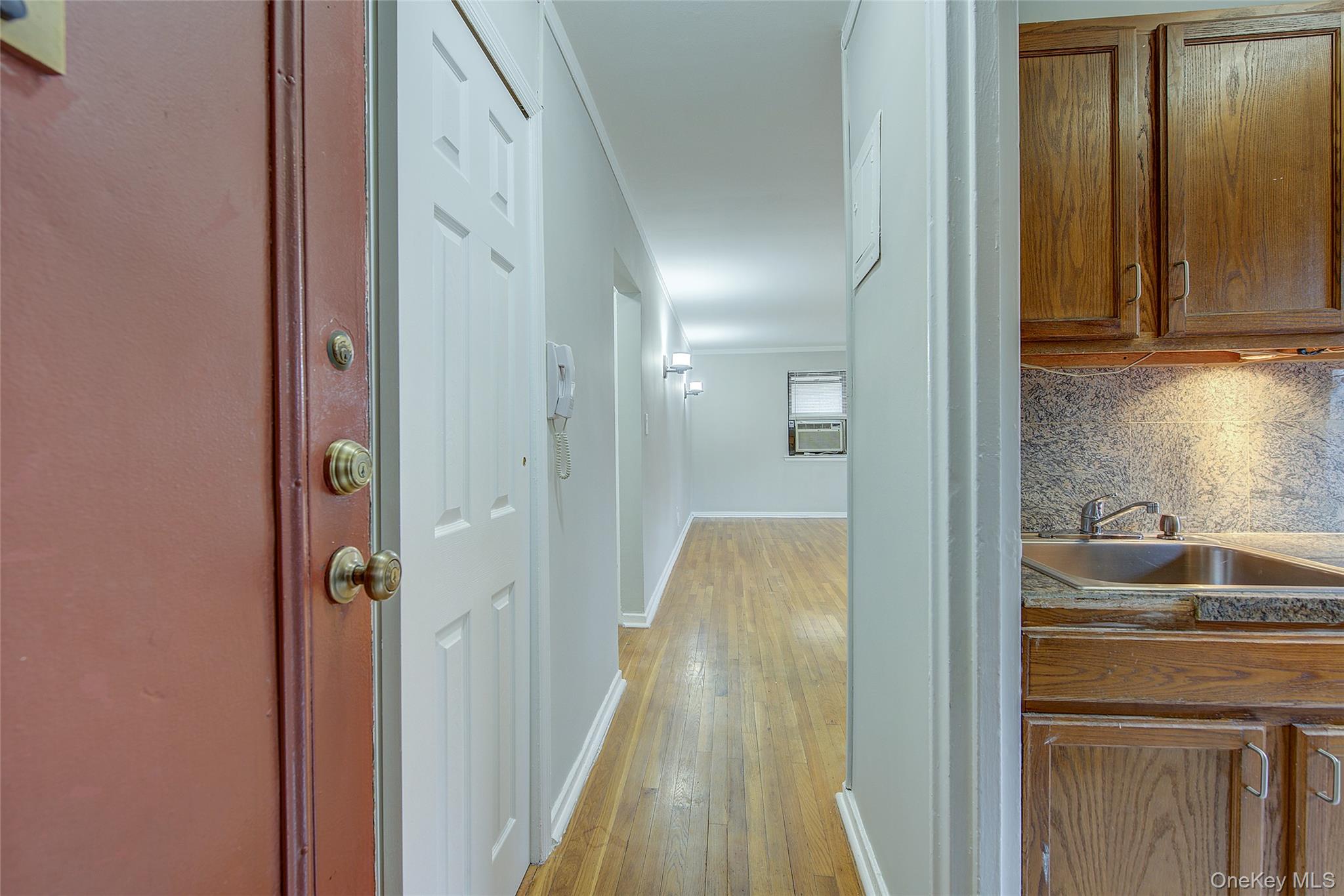 46-42 215th Place, Unit 1C Queens, NY 11361 - Photo 4 of 28 a view of bathroom with a sink mirror and shower