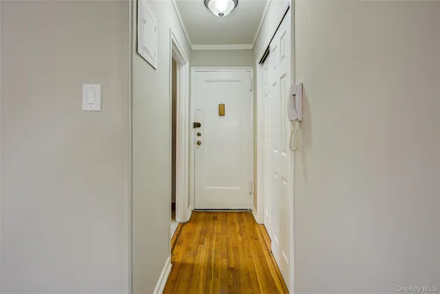 a view of a hallway with wooden floor and staircase