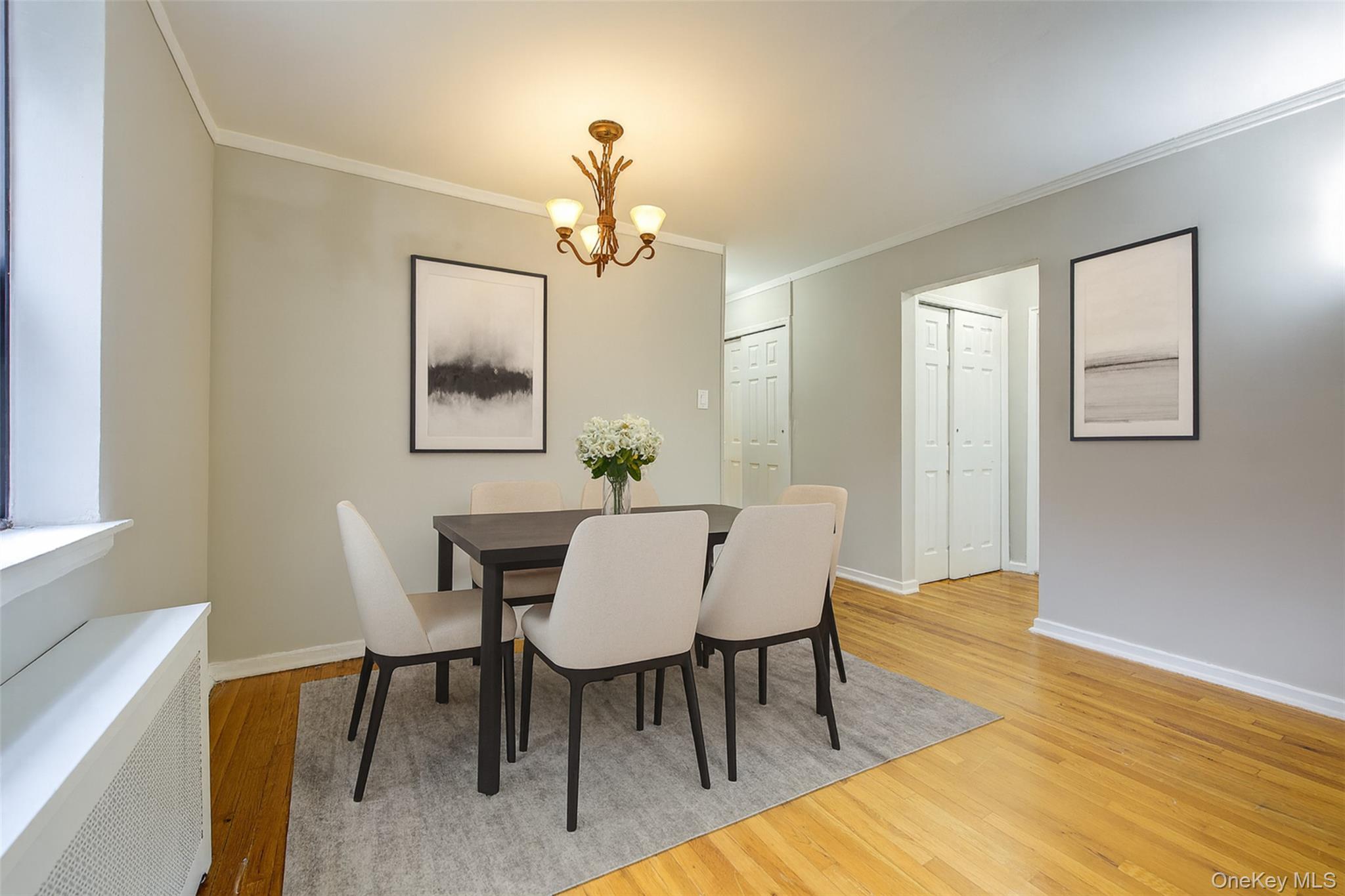 46-42 215th Place, Unit 1C Queens, NY 11361 - Photo 10 of 28 a view of a dining room with furniture and wooden floor