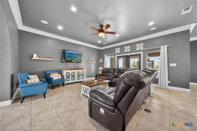 a living room with furniture a piano and a flat screen tv