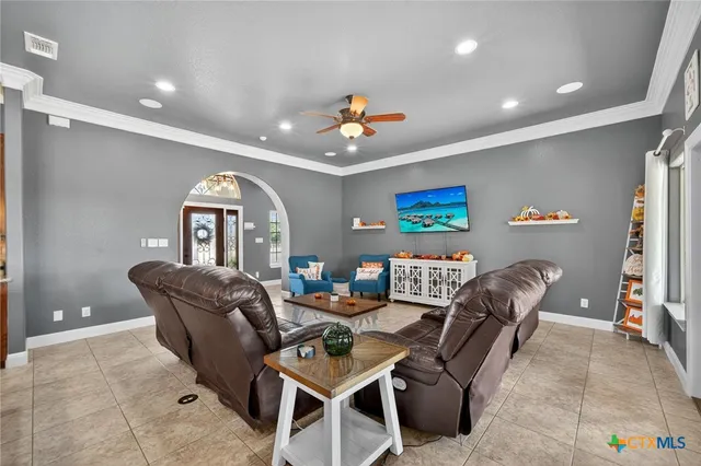 a living room with furniture potted plant and a chandelier