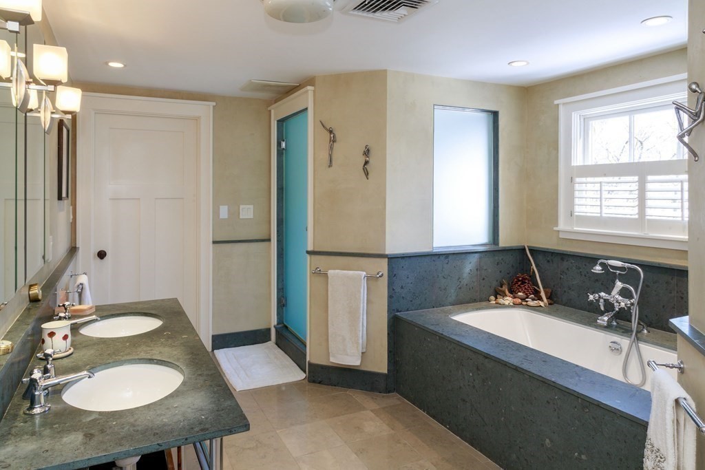 27 Metacomet Road Newton, MA 02468 - Photo 11 of 22 a bathroom with a sink double vanity granite tub shower and a mirror
