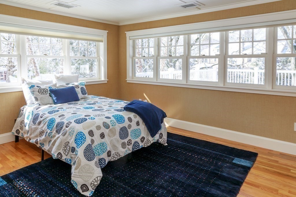 27 Metacomet Road Newton, MA 02468 - Photo 13 of 22 a bed sitting in a bedroom next to a window