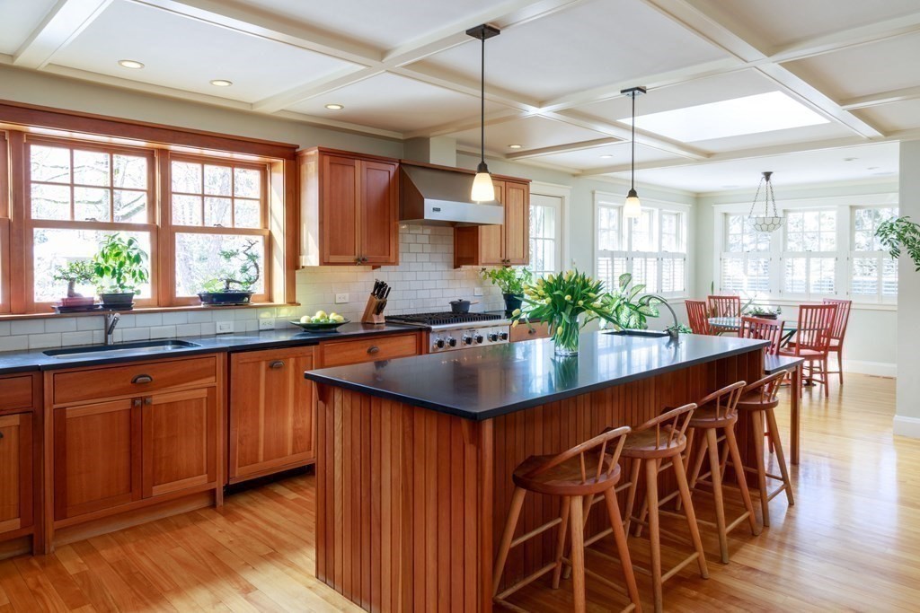 27 Metacomet Road Newton, MA 02468 - Photo 4 of 22 a kitchen with stainless steel appliances kitchen island a large window and wooden floor