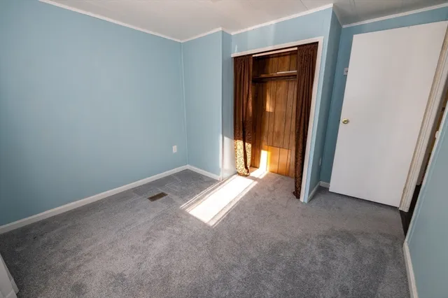 an empty room with closet area