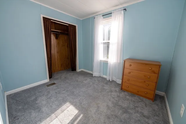 an empty room with windows and closet