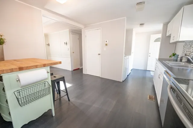 a kitchen with stainless steel appliances granite countertop a stove a sink a refrigerator and a wooden cabinets