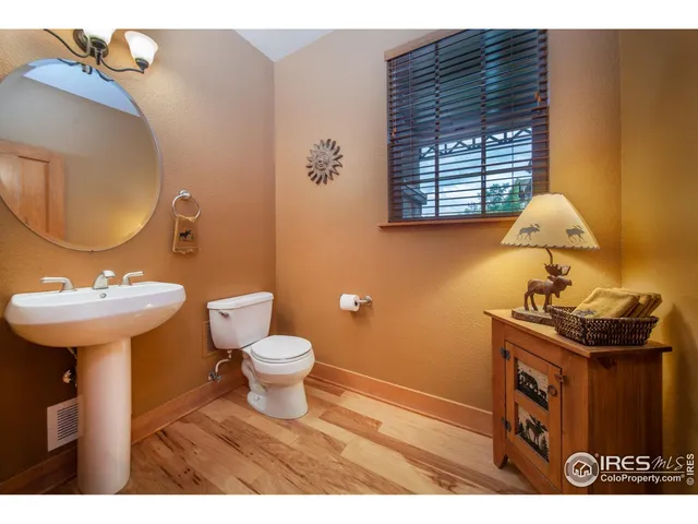 a bathroom with a sink a toilet and mirror