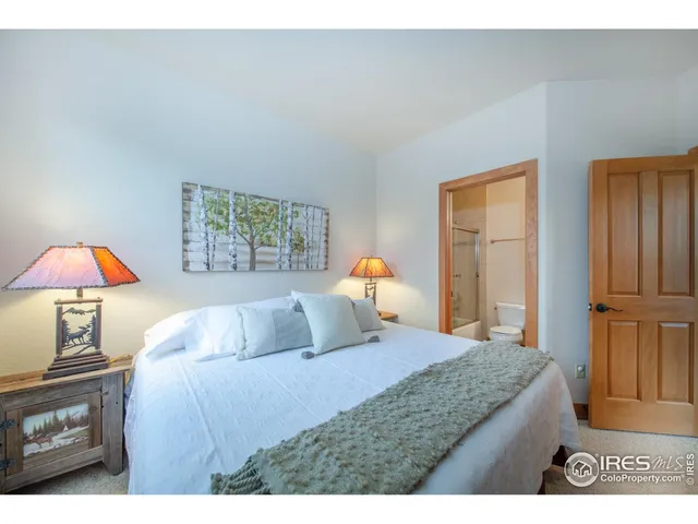 a bedroom with a bed and a night stand