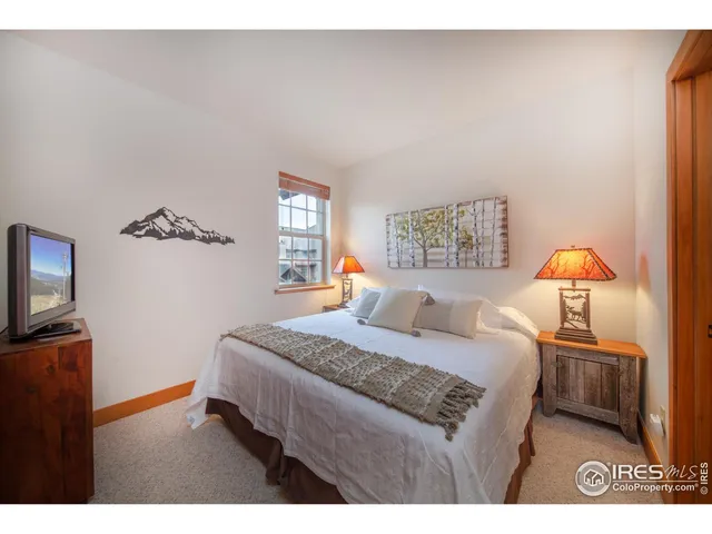 a bedroom with a bed and a lamp