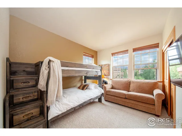 a bedroom with furniture and a large window