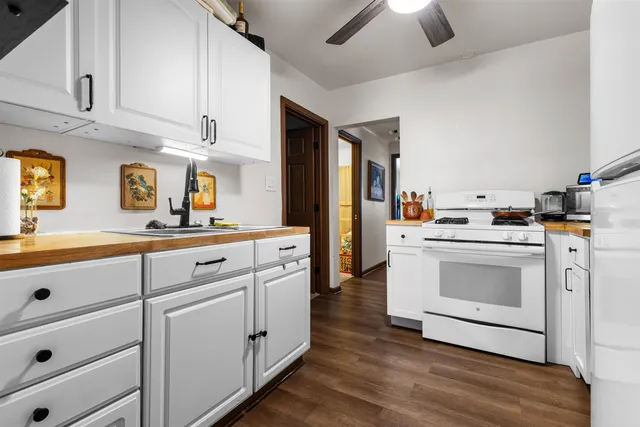 a kitchen with stainless steel appliances white cabinets and a refrigerator