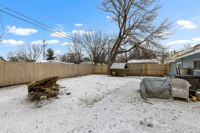 a view of a house with a yard covered in snow