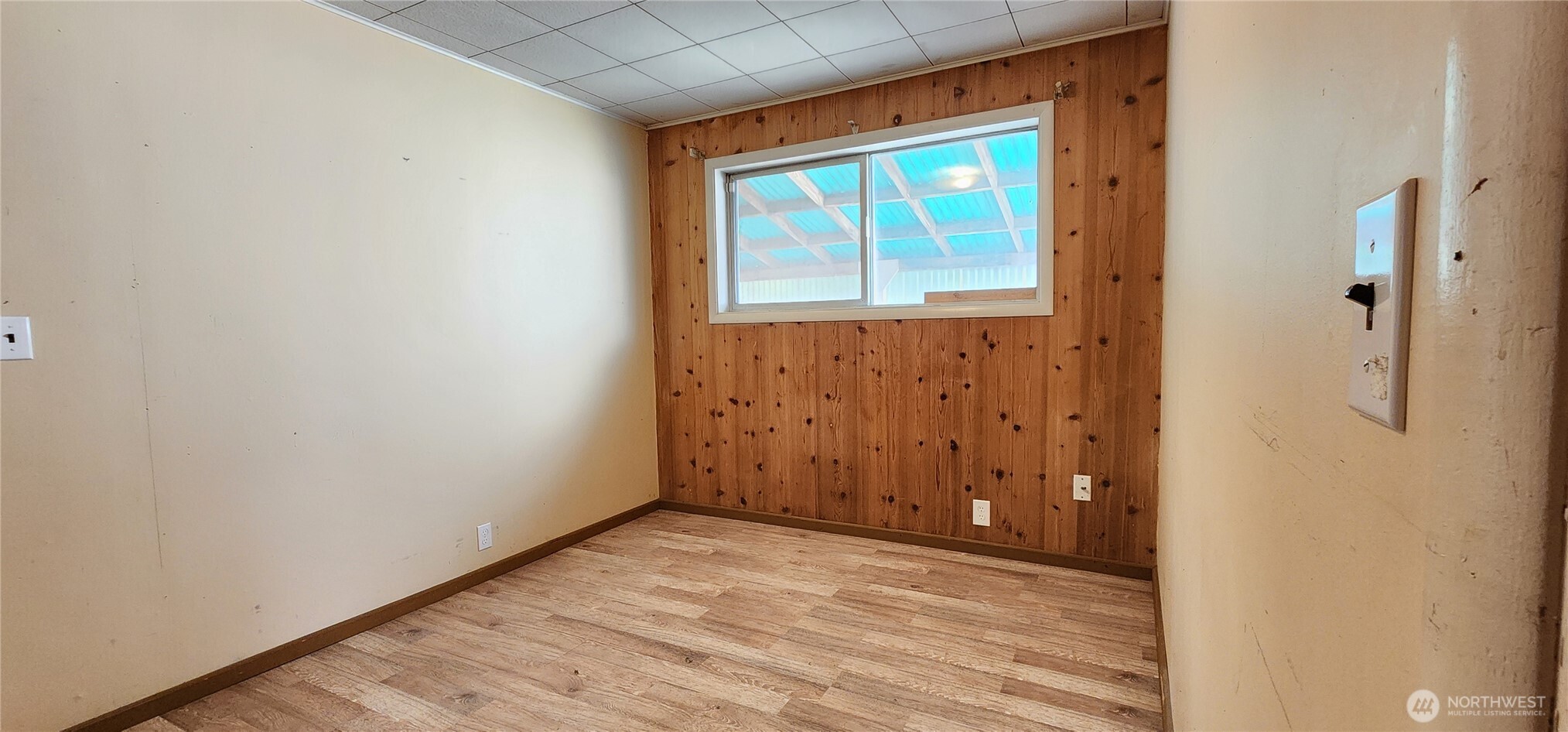 1216 Kaiser Road Southwest Olympia, WA 98512 - Photo 11 of 31 a view of an empty room with wooden floor and a window