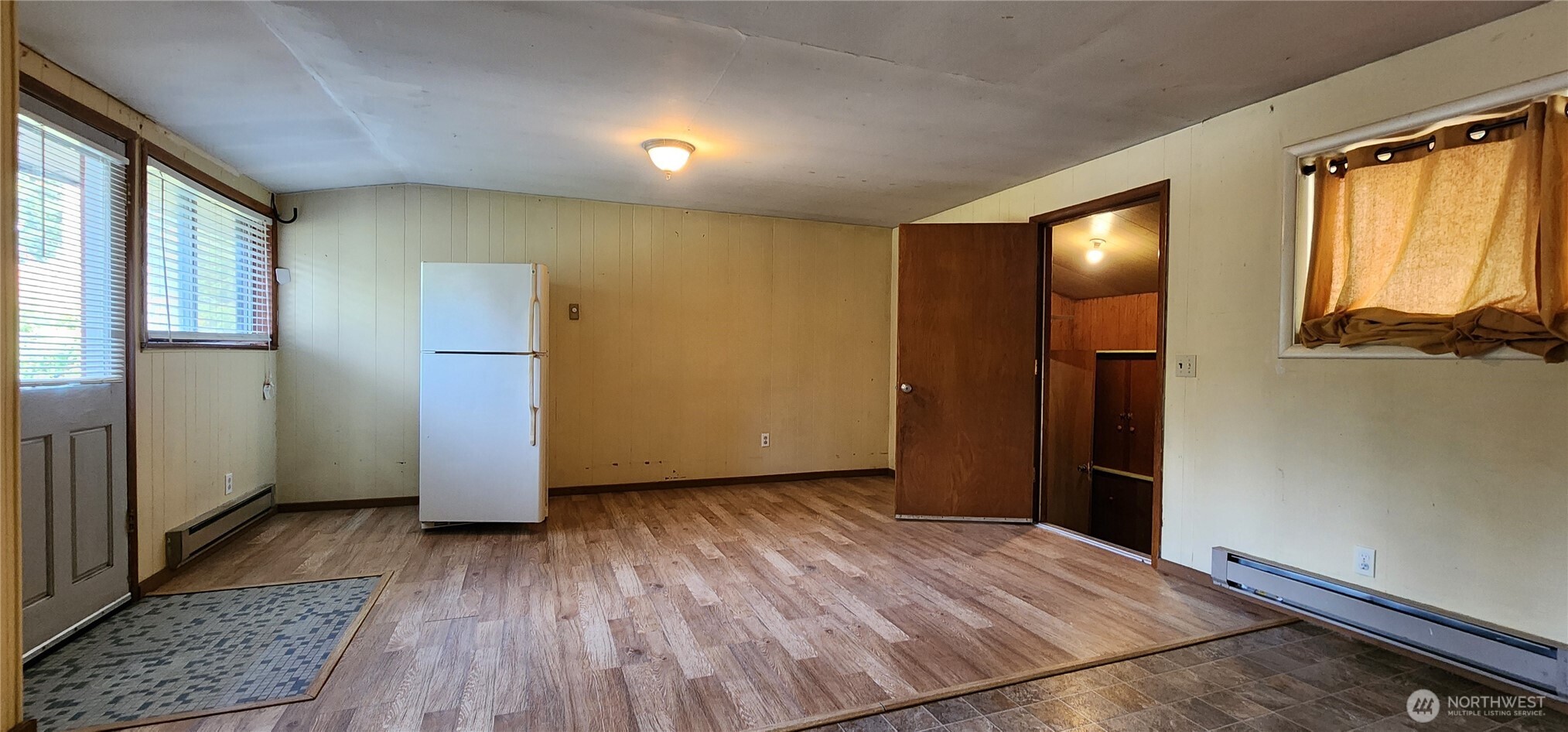 1216 Kaiser Road Southwest Olympia, WA 98512 - Photo 13 of 31 an empty room with wooden floor and windows