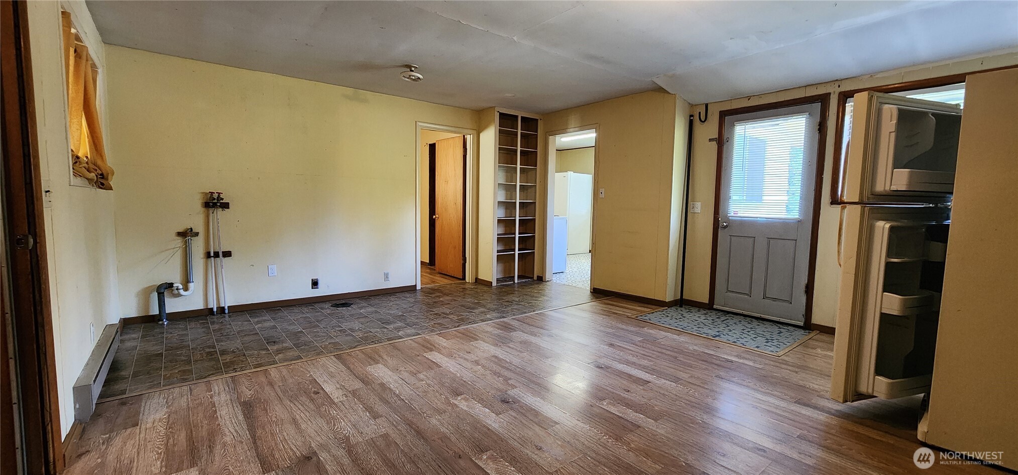 1216 Kaiser Road Southwest Olympia, WA 98512 - Photo 15 of 31 a view of empty room with wooden floor and windows