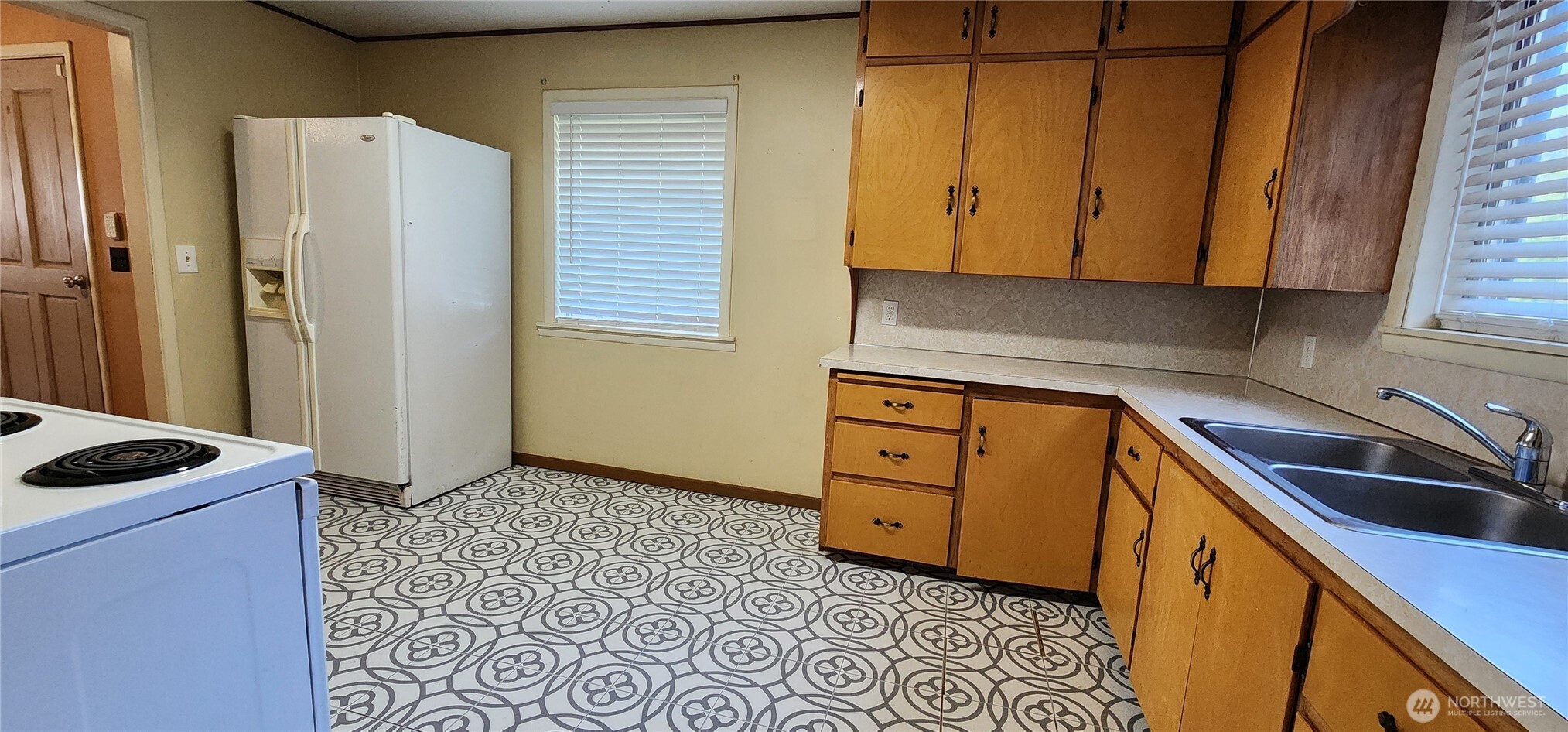 1216 Kaiser Road Southwest Olympia, WA 98512 - Photo 7 of 31 a kitchen with stainless steel appliances granite countertop a sink a refrigerator a stove a washer and dryer