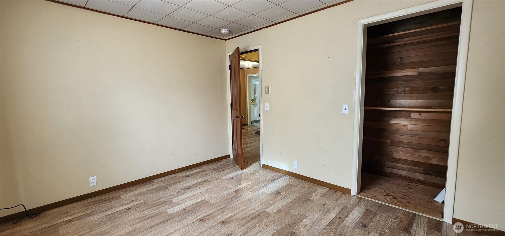 1216 Kaiser Road Southwest Olympia, WA 98512 - Photo 9 of 31 an empty room with wooden floor and entrance door