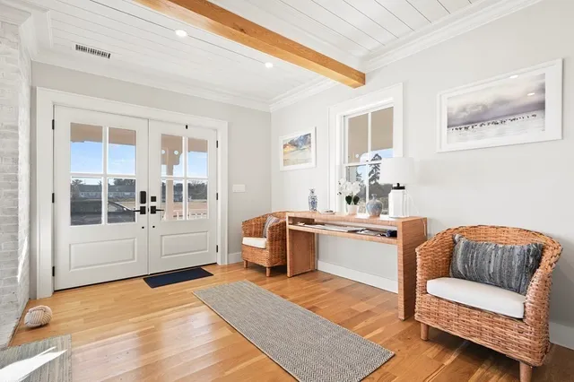 a view of a dining room with furniture wooden floor and chandelier
