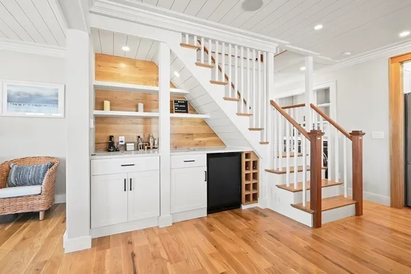 a view of a dining room with furniture a chandelier and wooden floor