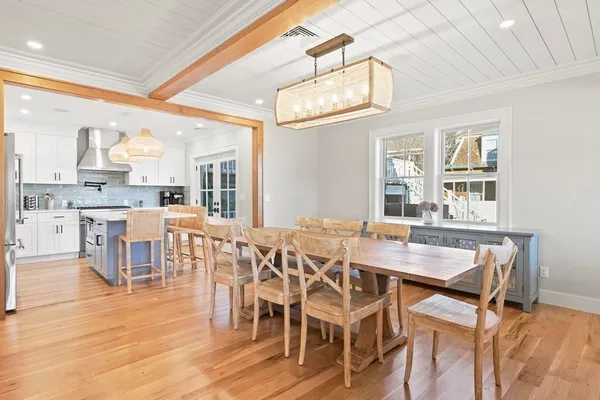 a kitchen with stainless steel appliances granite countertop a stove a sink dishwasher and a refrigerator with wooden floor