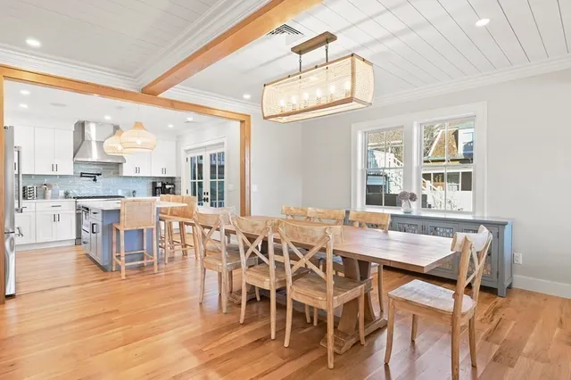 a kitchen with stainless steel appliances granite countertop a stove a sink dishwasher and a refrigerator with wooden floor