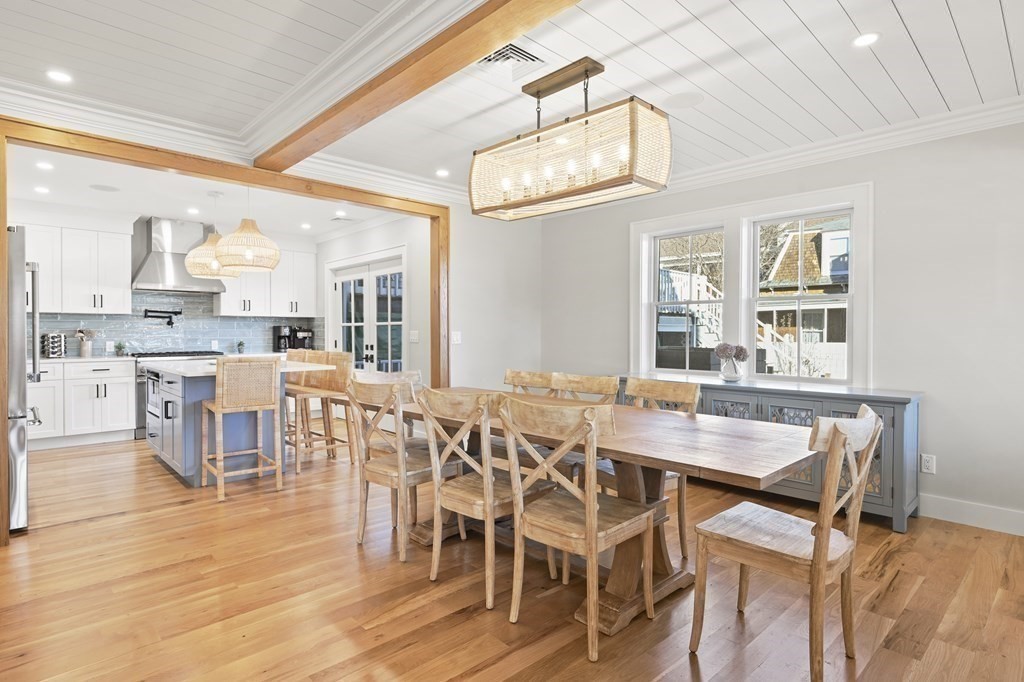 9 Tuckernuck Avenue Oak Bluffs, MA 02557 - Photo 17 of 30 a view of a dining room with furniture a chandelier and wooden floor