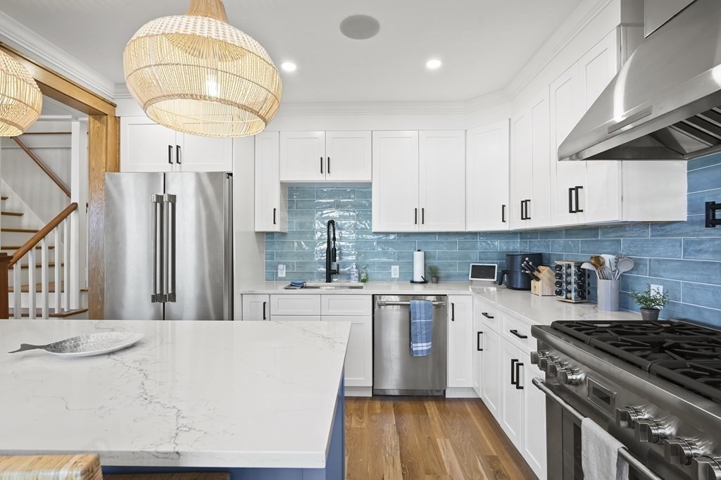 9 Tuckernuck Avenue Oak Bluffs, MA 02557 - Photo 18 of 30 a kitchen with stainless steel appliances granite countertop a stove a sink dishwasher and a refrigerator with wooden floor