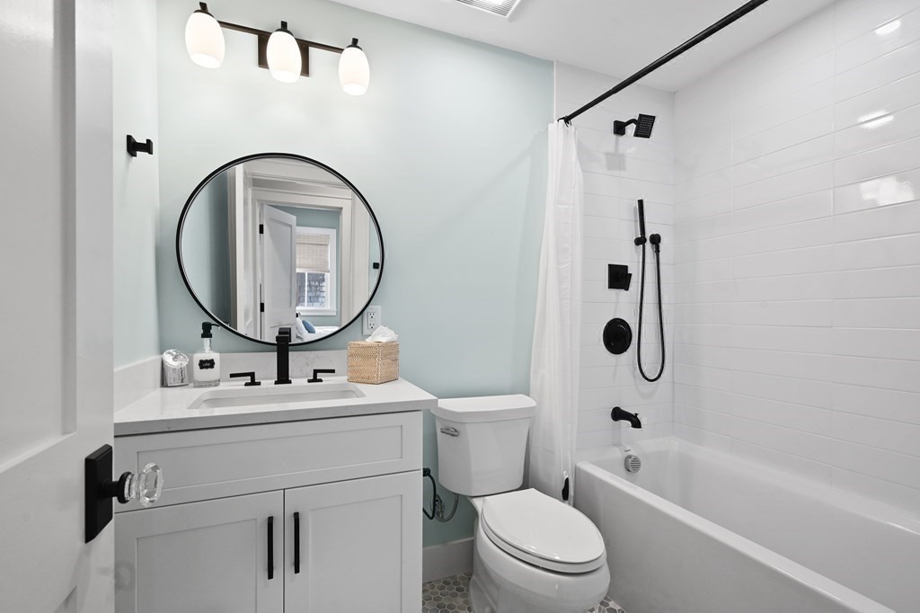 9 Tuckernuck Avenue Oak Bluffs, MA 02557 - Photo 22 of 30 a bathroom with a sink a toilet and a mirror