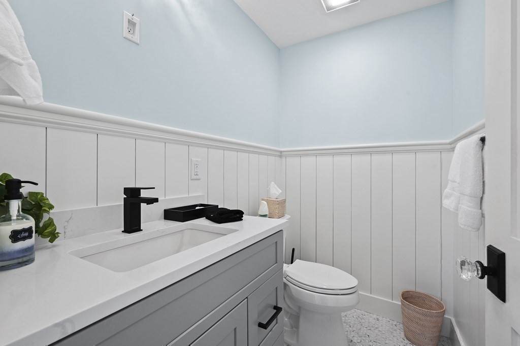 9 Tuckernuck Avenue Oak Bluffs, MA 02557 - Photo 24 of 30 a bathroom with a sink a toilet and shower curtain