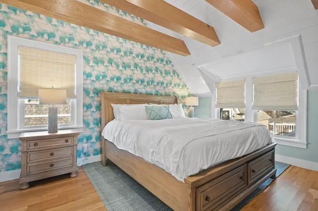 a bedroom with a bed and a window