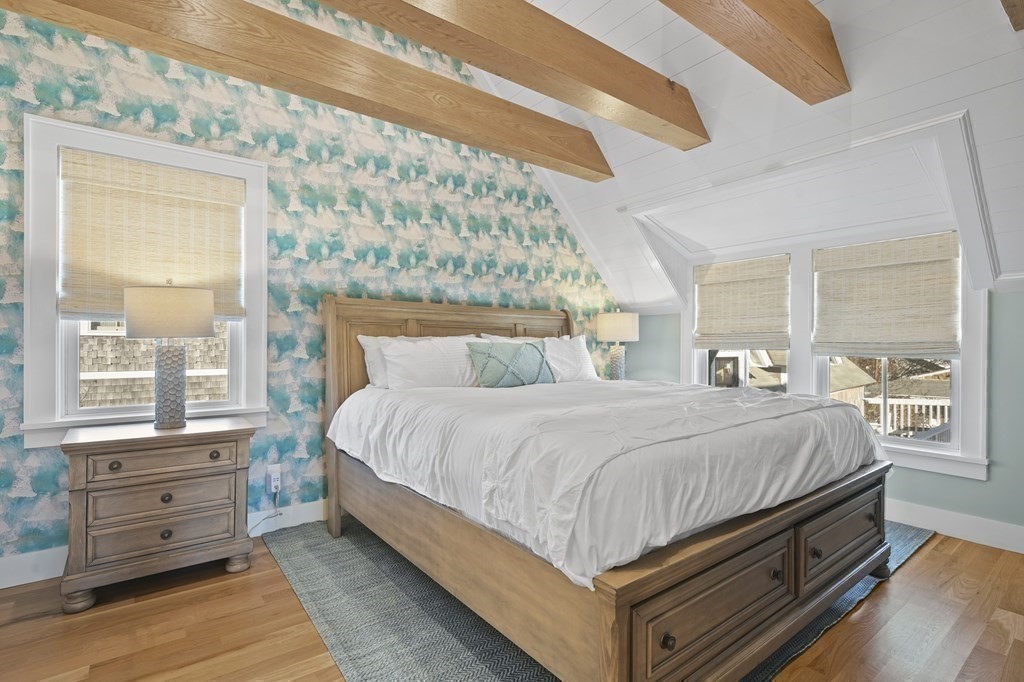 9 Tuckernuck Avenue Oak Bluffs, MA 02557 - Photo 27 of 30 a bed sitting in a bedroom next to a window