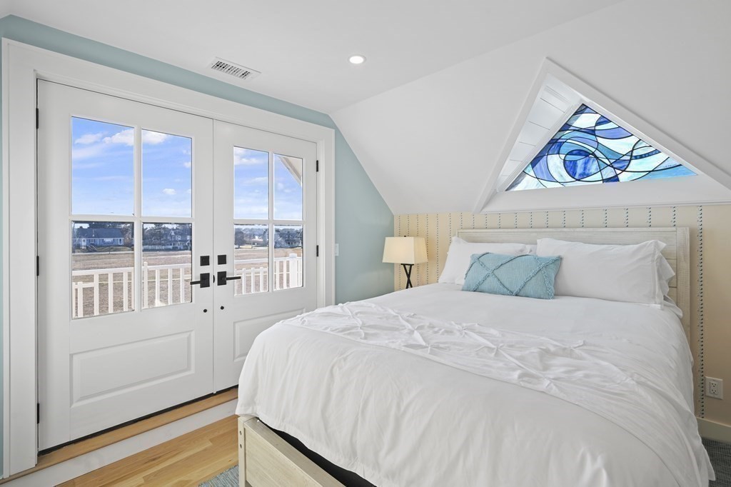 9 Tuckernuck Avenue Oak Bluffs, MA 02557 - Photo 5 of 30 a bedroom with a bed and a large window
