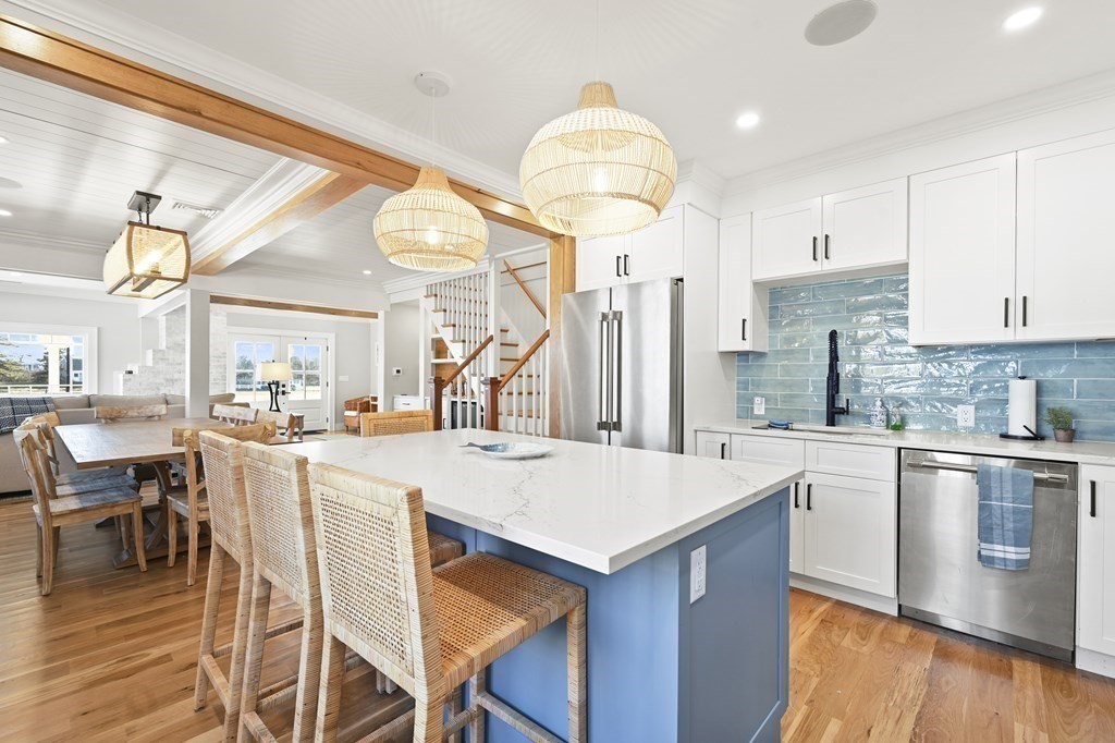 9 Tuckernuck Avenue Oak Bluffs, MA 02557 - Photo 7 of 30 a kitchen with a table and chairs in it