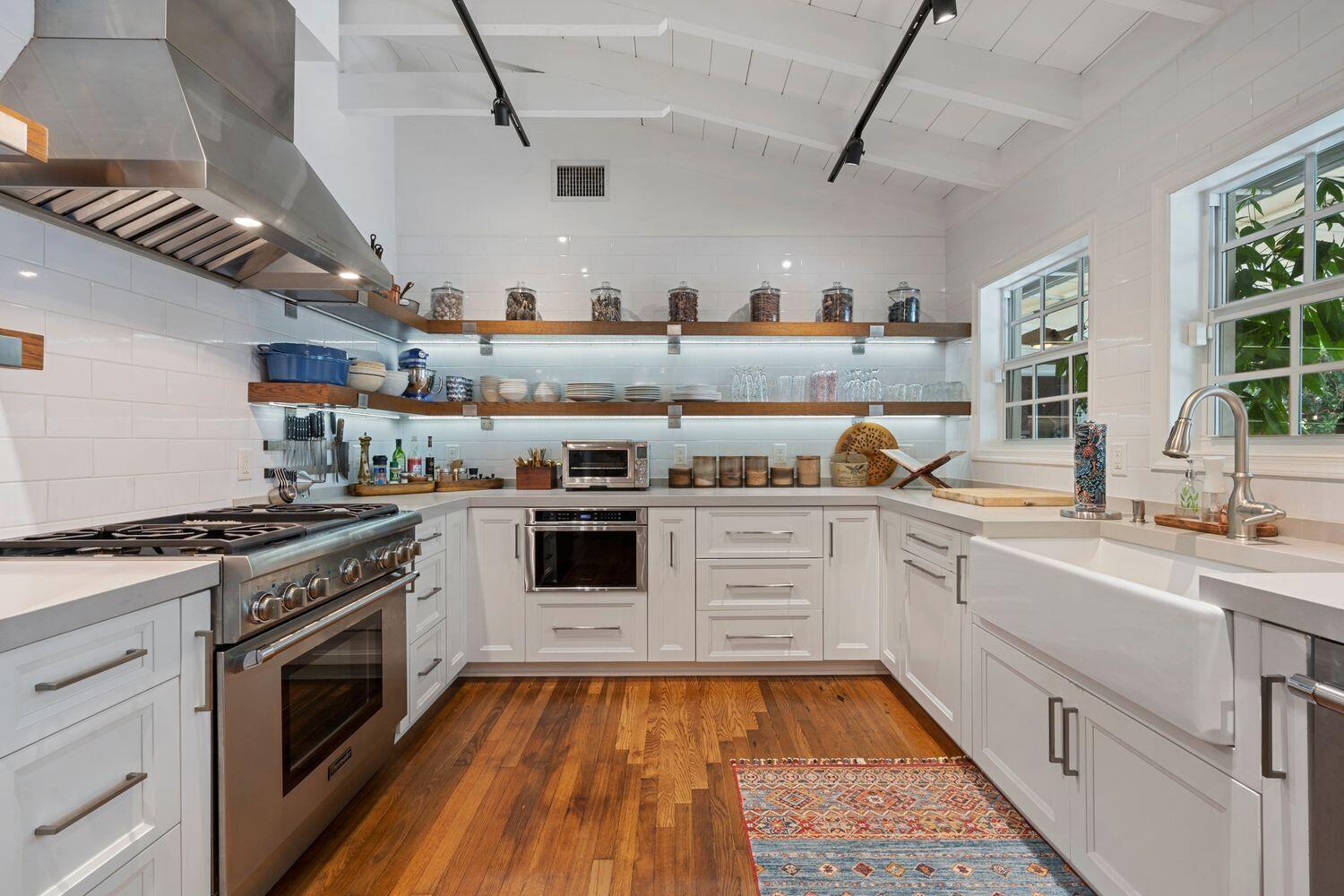 302 Northwest 16th Street Delray Beach, FL 33444 - Photo 14 of 46 a white kitchen with a stove top oven and sink