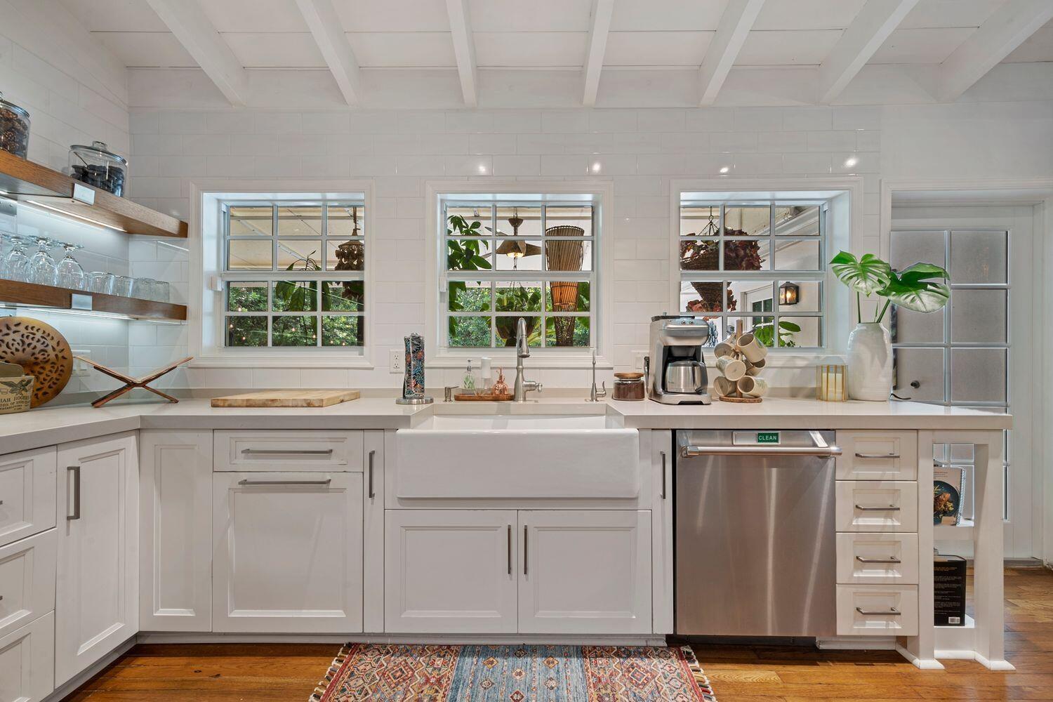 302 Northwest 16th Street Delray Beach, FL 33444 - Photo 15 of 46 a kitchen with stainless steel appliances granite countertop a sink and a white cabinets