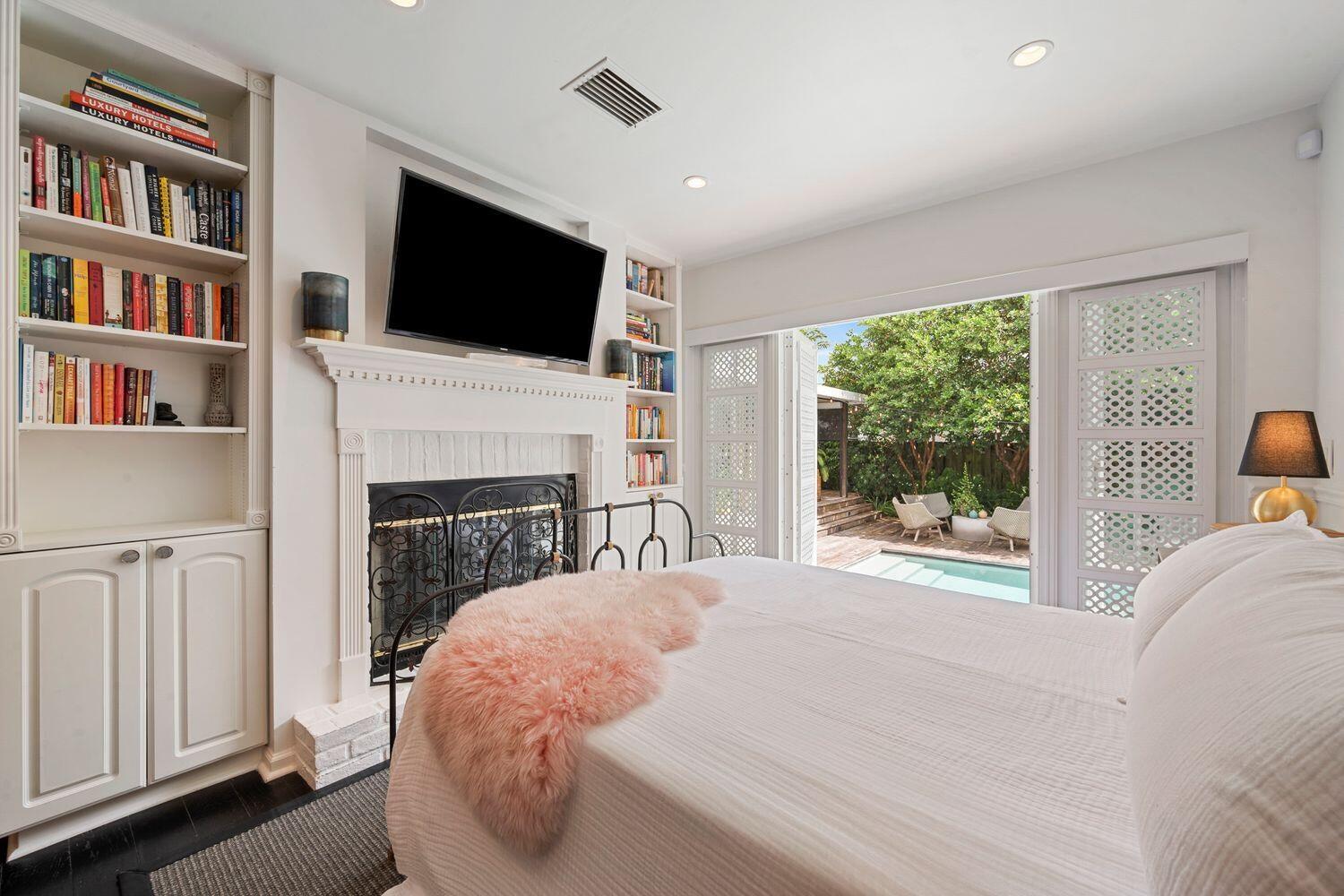 302 Northwest 16th Street Delray Beach, FL 33444 - Photo 21 of 46 a bed sitting in a living room with a flat screen tv