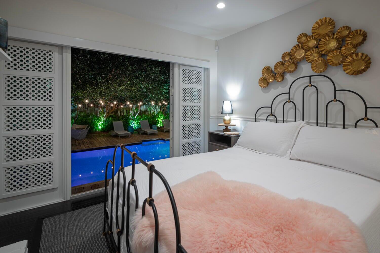 302 Northwest 16th Street Delray Beach, FL 33444 - Photo 22 of 46 a bed sitting in a bedroom next to a window