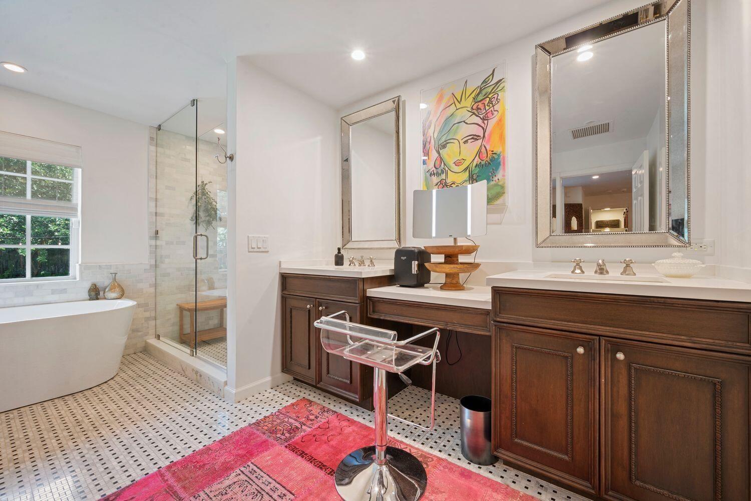 302 Northwest 16th Street Delray Beach, FL 33444 - Photo 25 of 46 a spacious bathroom with a double vanity sink a mirror a bathtub and next to a window