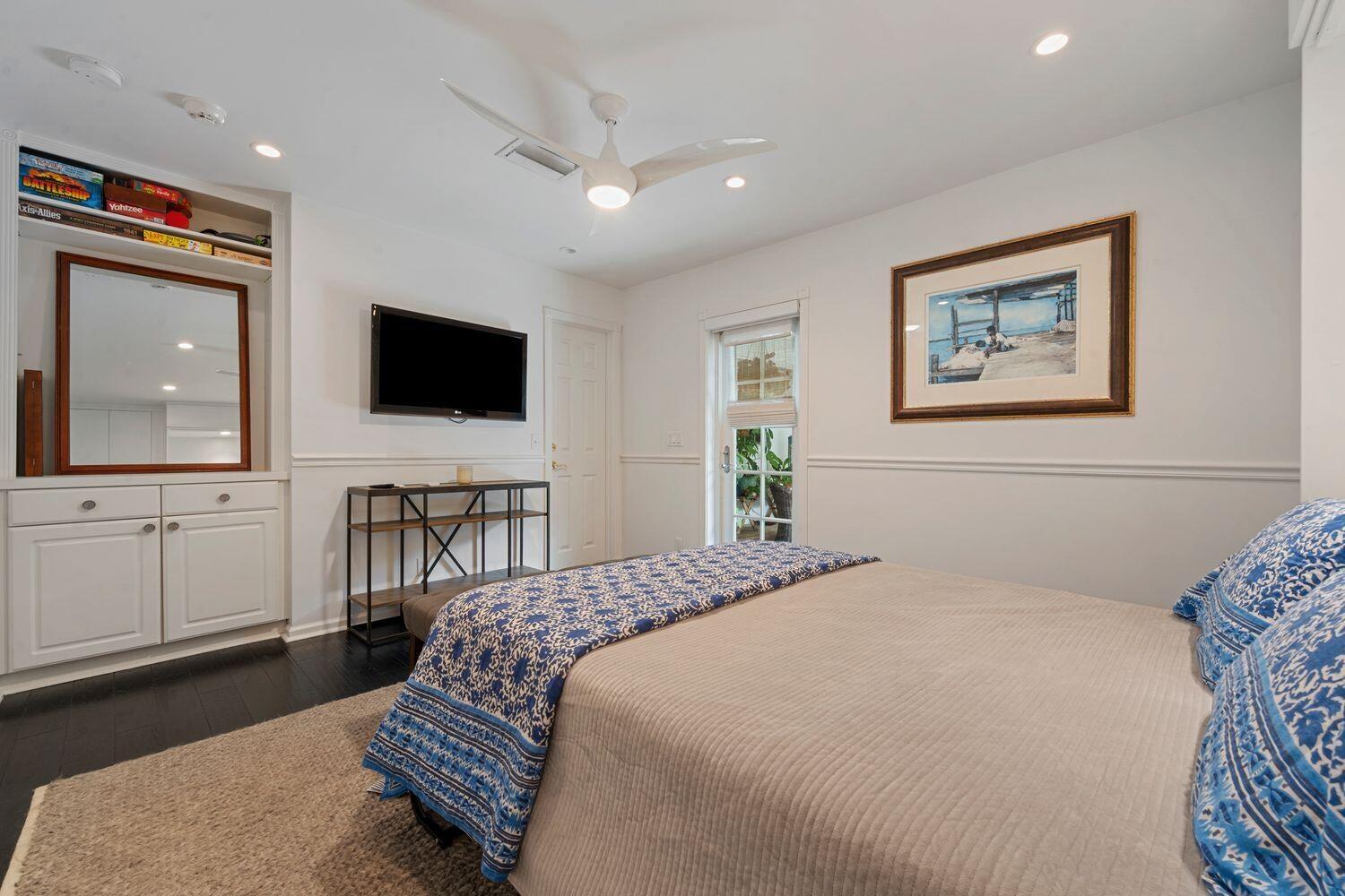 302 Northwest 16th Street Delray Beach, FL 33444 - Photo 30 of 46 a bedroom with a bed and a flat screen tv