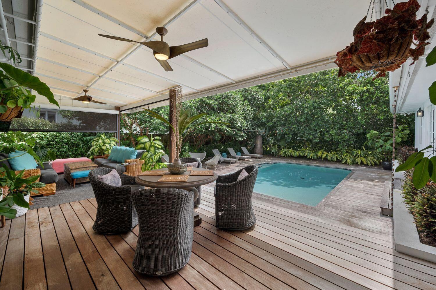 302 Northwest 16th Street Delray Beach, FL 33444 - Photo 39 of 46 a view of a patio with table and chairs potted plants with wooden floor