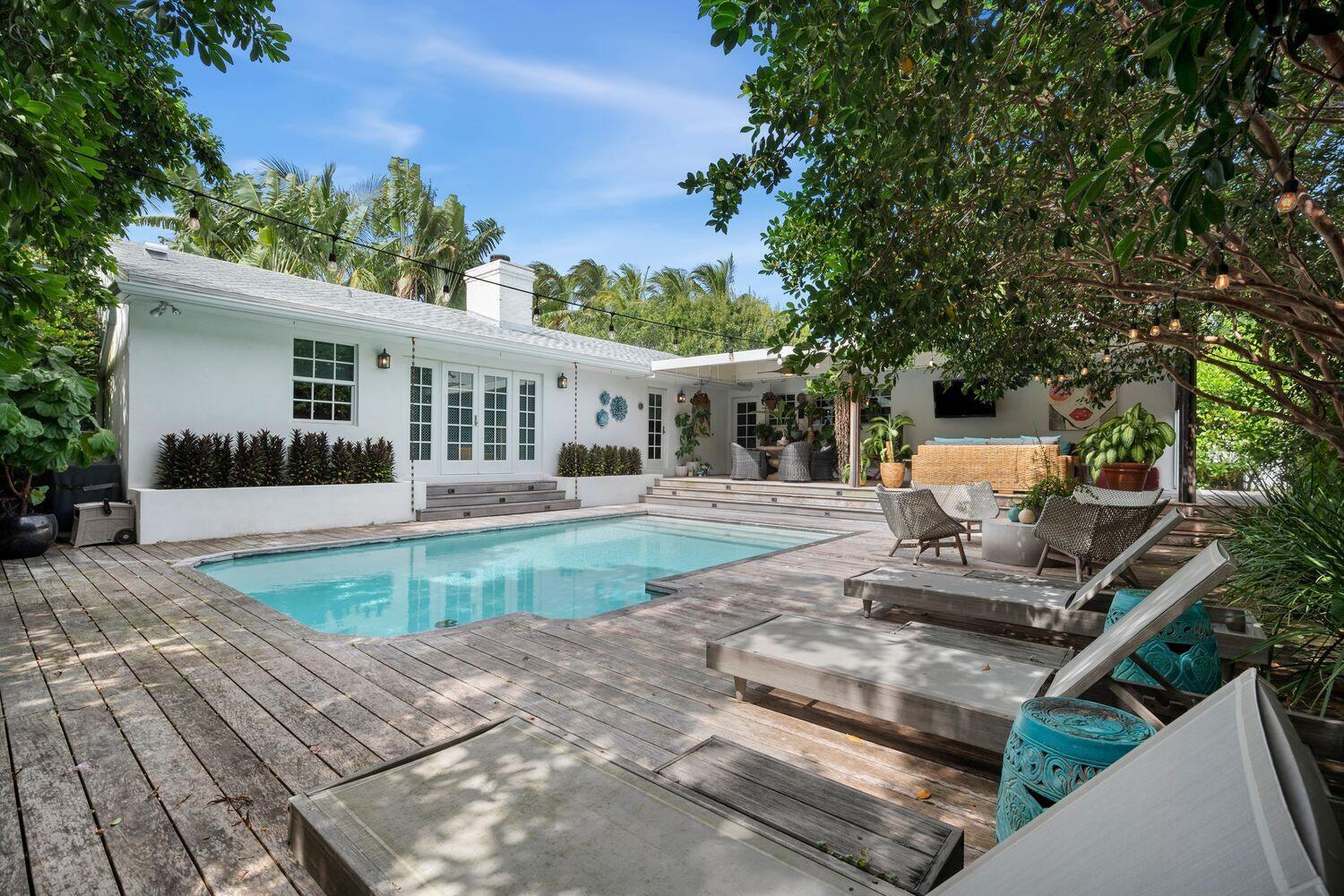 302 Northwest 16th Street Delray Beach, FL 33444 - Photo 45 of 46 a view of a house with backyard sitting area and garden