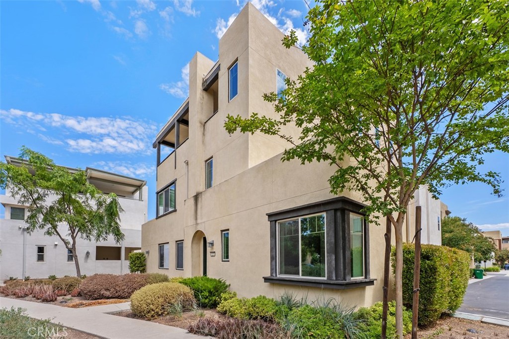 123 Interval Irvine, CA 92618 - Photo 1 of 75 a front view of a house with a garden