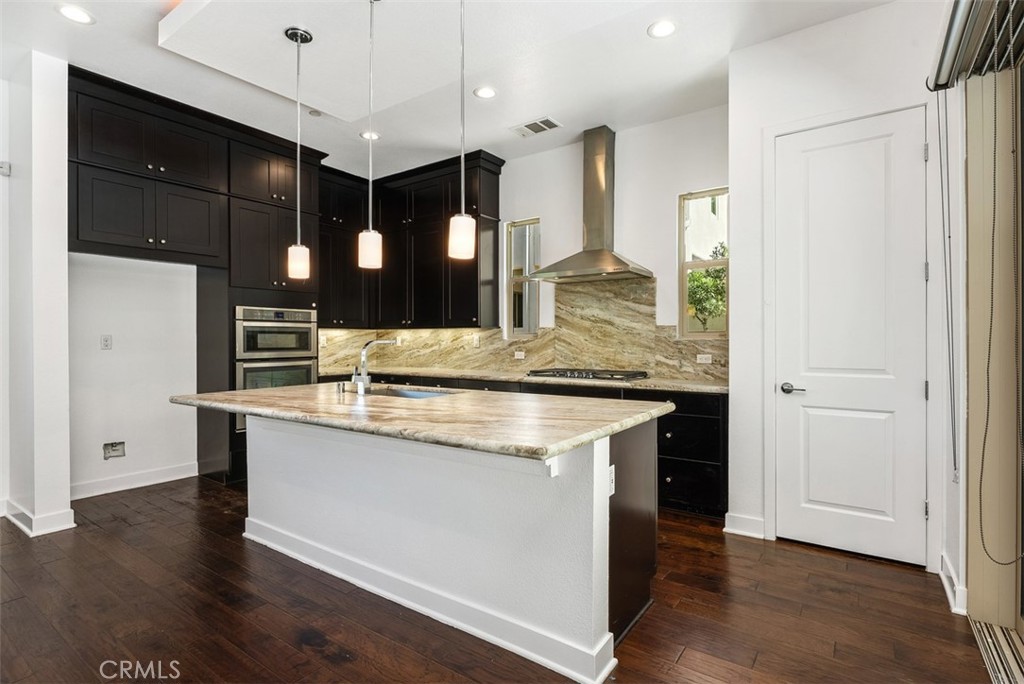 123 Interval Irvine, CA 92618 - Photo 11 of 75 a kitchen with stainless steel appliances granite countertop wooden floors and granite counter tops