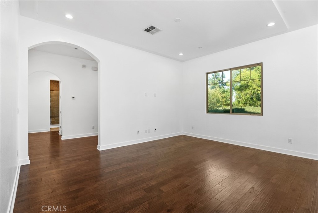 123 Interval Irvine, CA 92618 - Photo 24 of 75 an empty room with wooden floor and windows