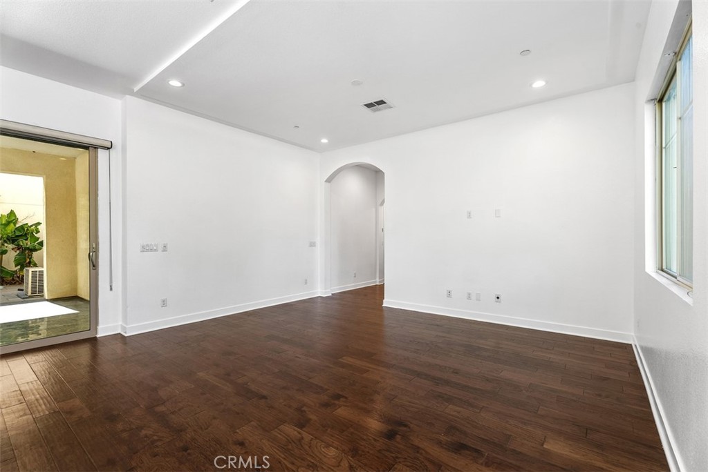 123 Interval Irvine, CA 92618 - Photo 25 of 75 an empty room with wooden floor and windows